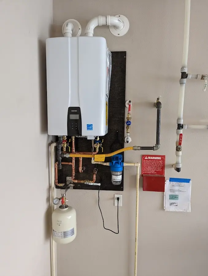 Professional plumber installing copper piping in a Shirley home